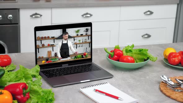 Laptop Computer with Man Chef Food Blogger in Screen Tells Teaches Student alt