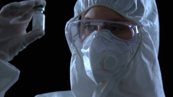 Scientist Demonstrating White Powder in Bottle With, Vaccine Development, Lab alt