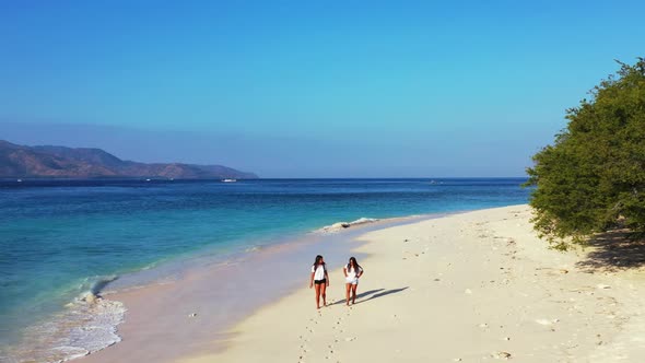 Women happy and smiling on beautiful island beach journey by transparent water and white sandy backg alt