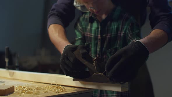 Father Teaches His Son To Use a Planer. Paternity alt