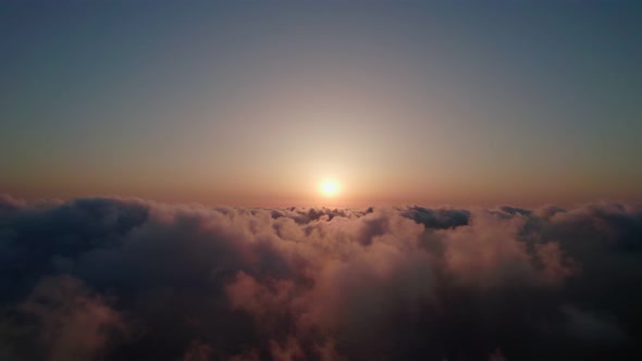 Fly through the clouds during sunrise.