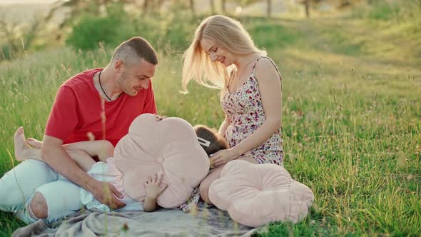 Young married couple with cute little daughter have a good time together.  alt