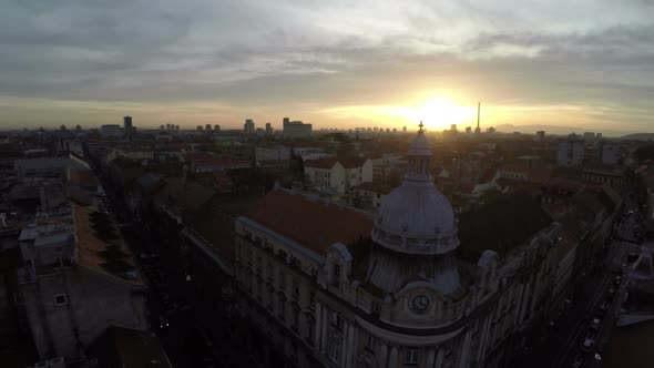 Aerial view of buildings at sunset alt