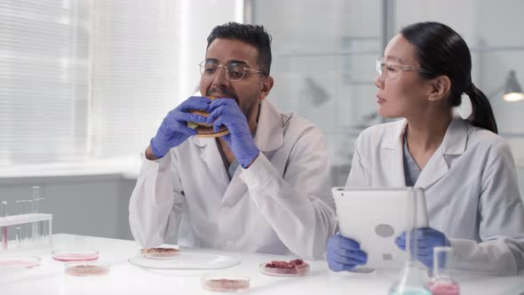 Man Trying Lab Burger With In Vitro Meat alt