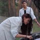 Side View Confident Young Woman Repairing Automobile Leaning at Open Car Hood with Blurred Man - VideoHive Item for Sale