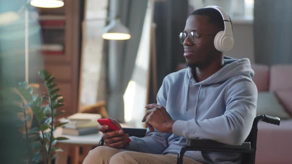 Portrait of Happy Man on Wheelchair Listening to Music alt