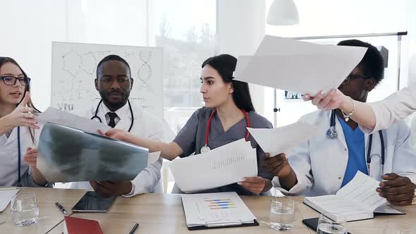 Team of Doctors Having a Meeting in Conference Room in the Modern Hospital alt