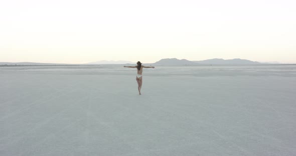 Girl walking away in the desert