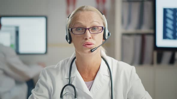 Senior Doctor Wearing Headset in Medical Consultation Call Center alt