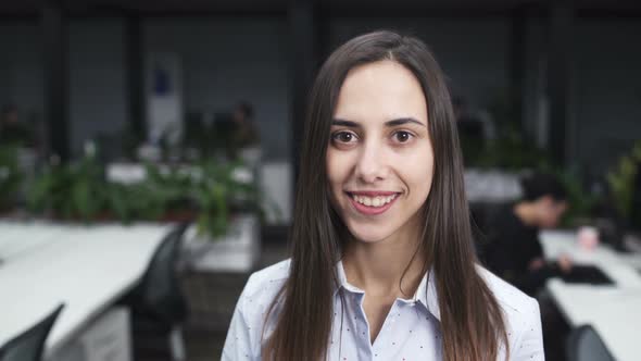 Happy Young Woman Employee Looking At Camera And Smiling