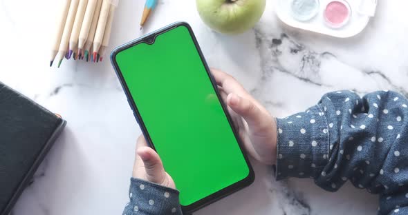 Flat Composition of Child Girl Using Smart Phone on Table alt