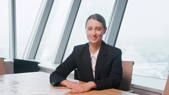 Listening young businesswoman on video conference in office alt