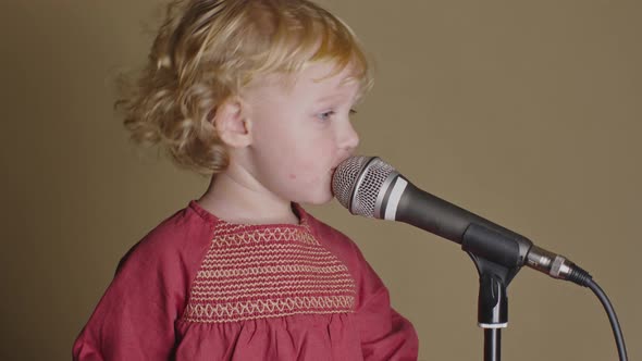 Cute Little Girl Sing Song Into Microphone, Funny Toddler Enjoing Broadcasting