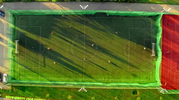 Aerial view of a sports field with footballers playing, Poland alt