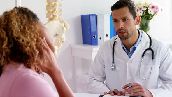 Patient suffering from pain while consulting Physiotherapist alt