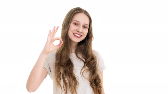 Closeup Portrait of Cheerful Student Girl Looking at Camera with Smile and Gesturing on Camera with alt