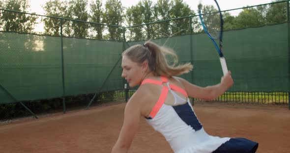 Attractive Young Sportswoman Hitting the Ball While Tennis Match Slow Motion alt