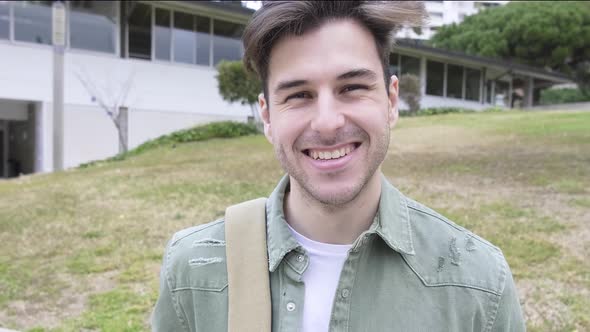 Happy student smiling at camera in college campus