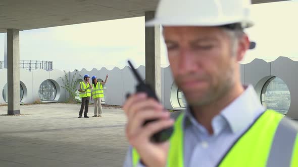 Man using walkietalkie at construction site