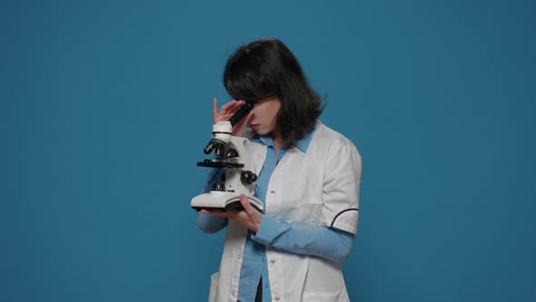 Chemistry Researcher Using Microscope with Magnifying Glass alt