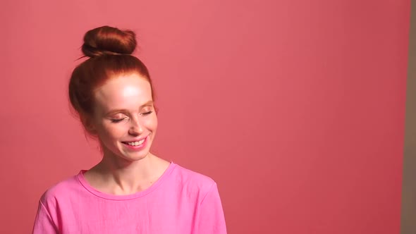 Redhaired Ginger Woman in Pink Studio Background Her Bun Fell Apart During Shaking Head alt