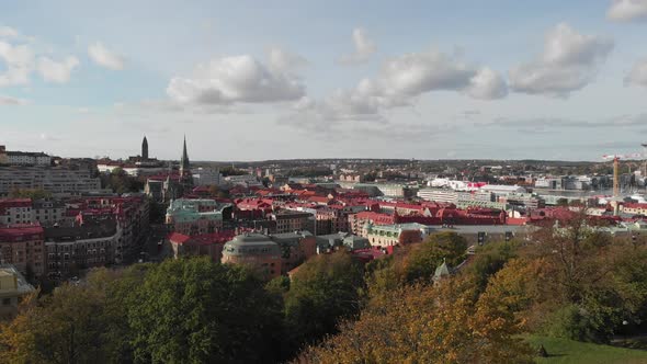 Gothenburg City Center Reveal Behind Trees Aerial Rising