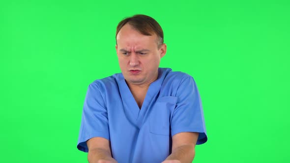 Medical Man Showing Disgust for Bad Smell or Taste. Green Screen alt