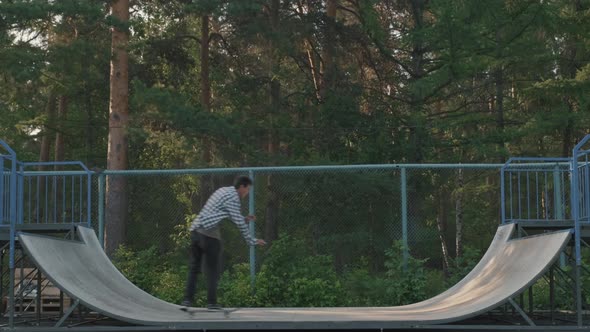 Young Man Skating on Half-Pipe Ramp alt