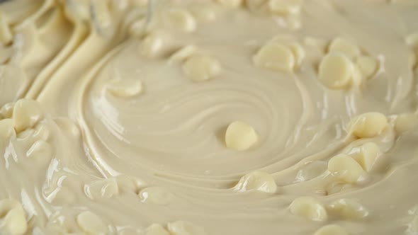 Process melt white chocolate. Stir chocolate chips and liquid white chocolate. alt