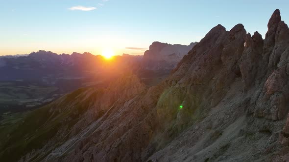 Dolomites mountains peaks with a hiking path on a summer sunrise alt