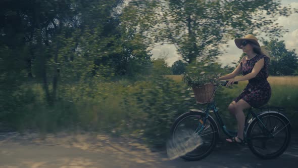 Lady Cycling. Woman With Blonde Hair Cycling. Beautiful Girl Hat. Happy Beautiful Girl With Bike. alt