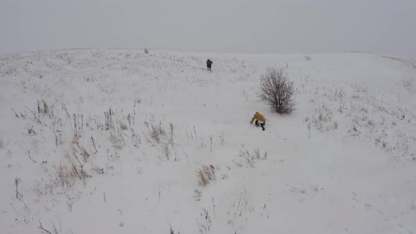 Two Men Climbed the Top of the Mountain Covered with Snow During the Fog