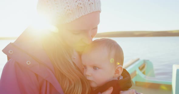 Mother with her baby travelling on motor boat alt