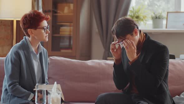 Man Crying on Therapy Session with Psychologist alt