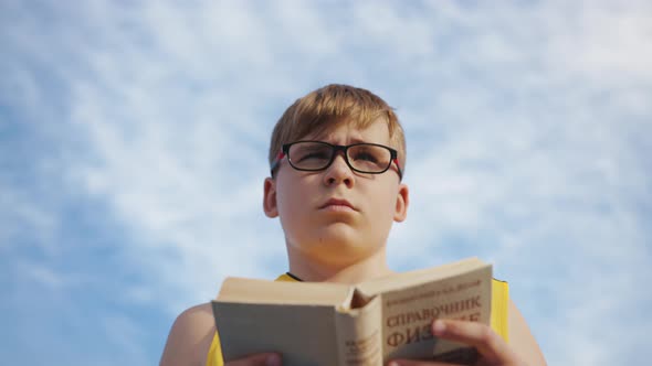 Young boy with a book, slow motion alt