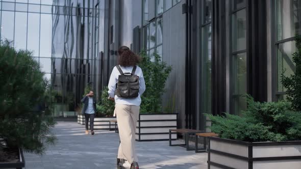 Office Manager Riding Kickscooter Downtown District Rear View alt