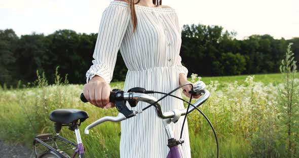 Woman Walking with Bicycle Countryside