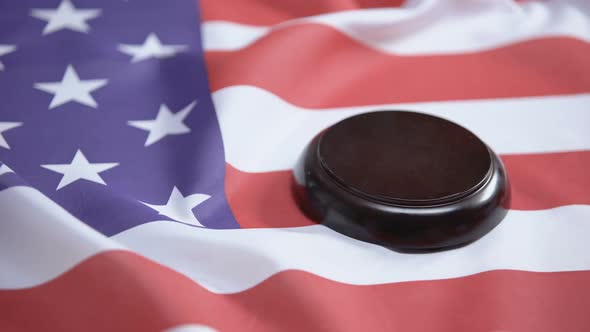 Gavel Striking on Sound Block Against American Flag, Case Law, Court System alt