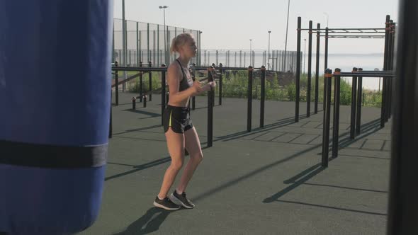 Young Sportswoman Skipping Rope Outdoors alt