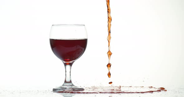 Red Wine being poured near a Glass, against White Background, Slow motion 4K