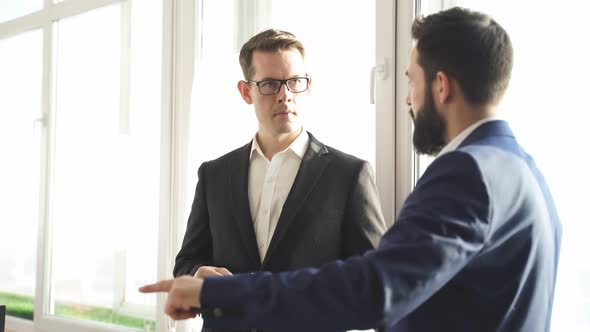Two Successful Confident Business Men Have Conversation
