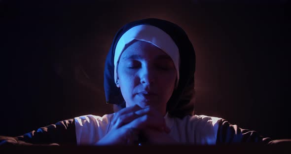 Nun Praying In The Dark0