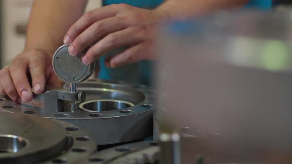 Engineer Checks Quality Parts of Wellhead Fittings and Butterfly Valves. Oil and Gas Wellhead Tree alt