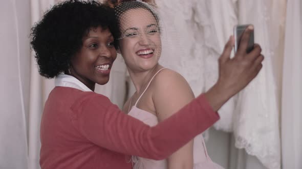 Mother making selfie with daughter in wedding dress