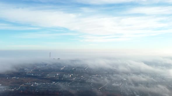 Aerial Drone View Flight Over Above Fog Mist and Roofs of Buildings in City alt