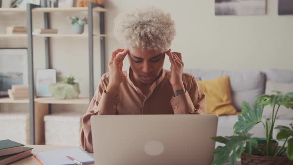 Exhausted African Female Employee Struggle with Blurry Vision or Dizziness alt