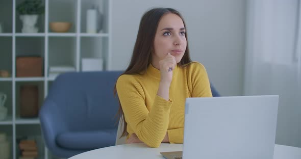 Thoughtful Concerned Indian Woman Working on Laptop Computer Looking Away Thinking Solving Problem alt