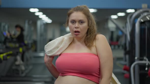 Selfassured Caucasian Plussize Woman Posing in Gym Indoors Looking at Camera Smiling alt