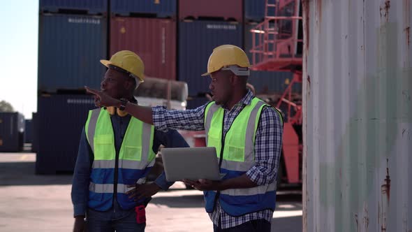 Dock workers team discuss shipping logistics in a shipyard, Factory worker team checking containers