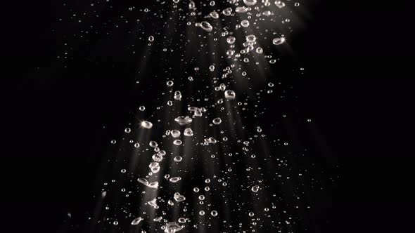 Soda water bubbles splashing underwater and floating water drop in black background. Motion picture
